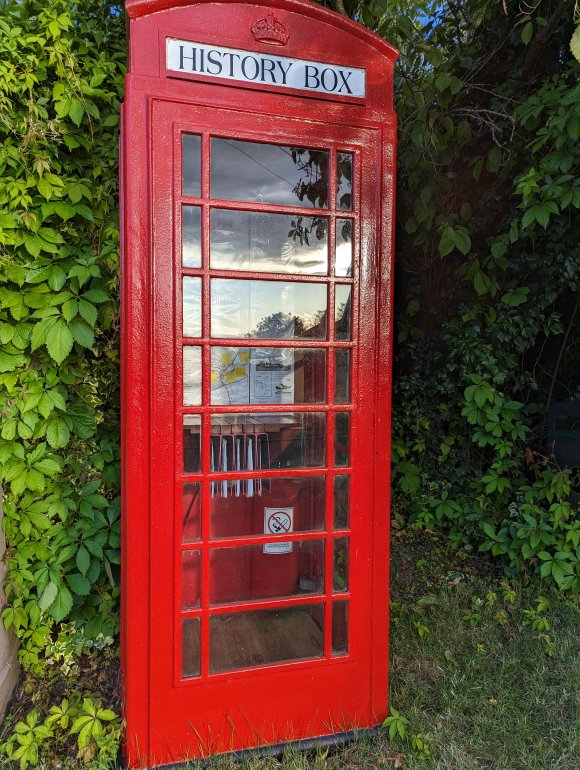 A telephone box converted to house historical information about the village